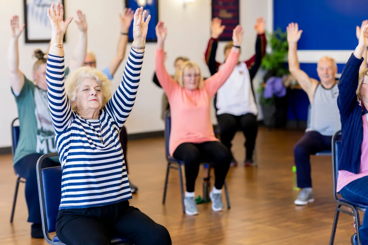 Older adults participating in a chair exercise class