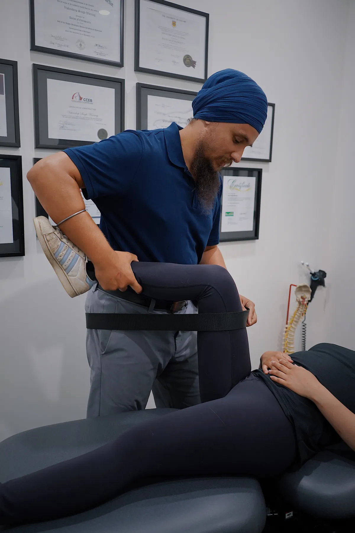 Physical therapist working with a patient on an examination table