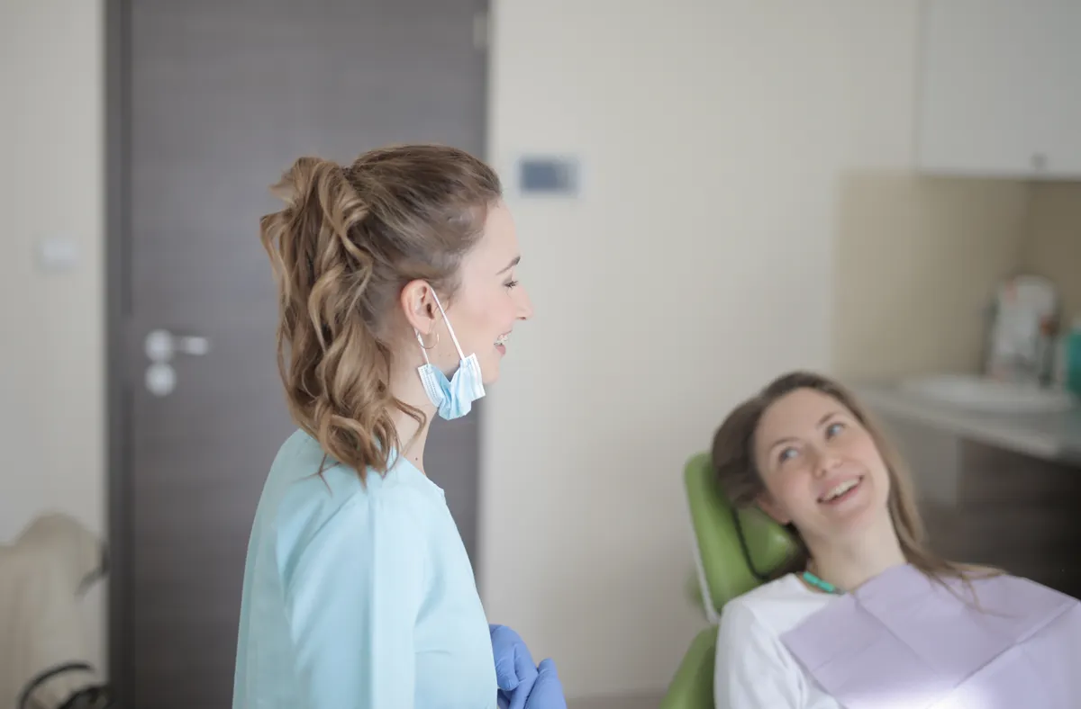 Dentist talking with a patient in a dental chair