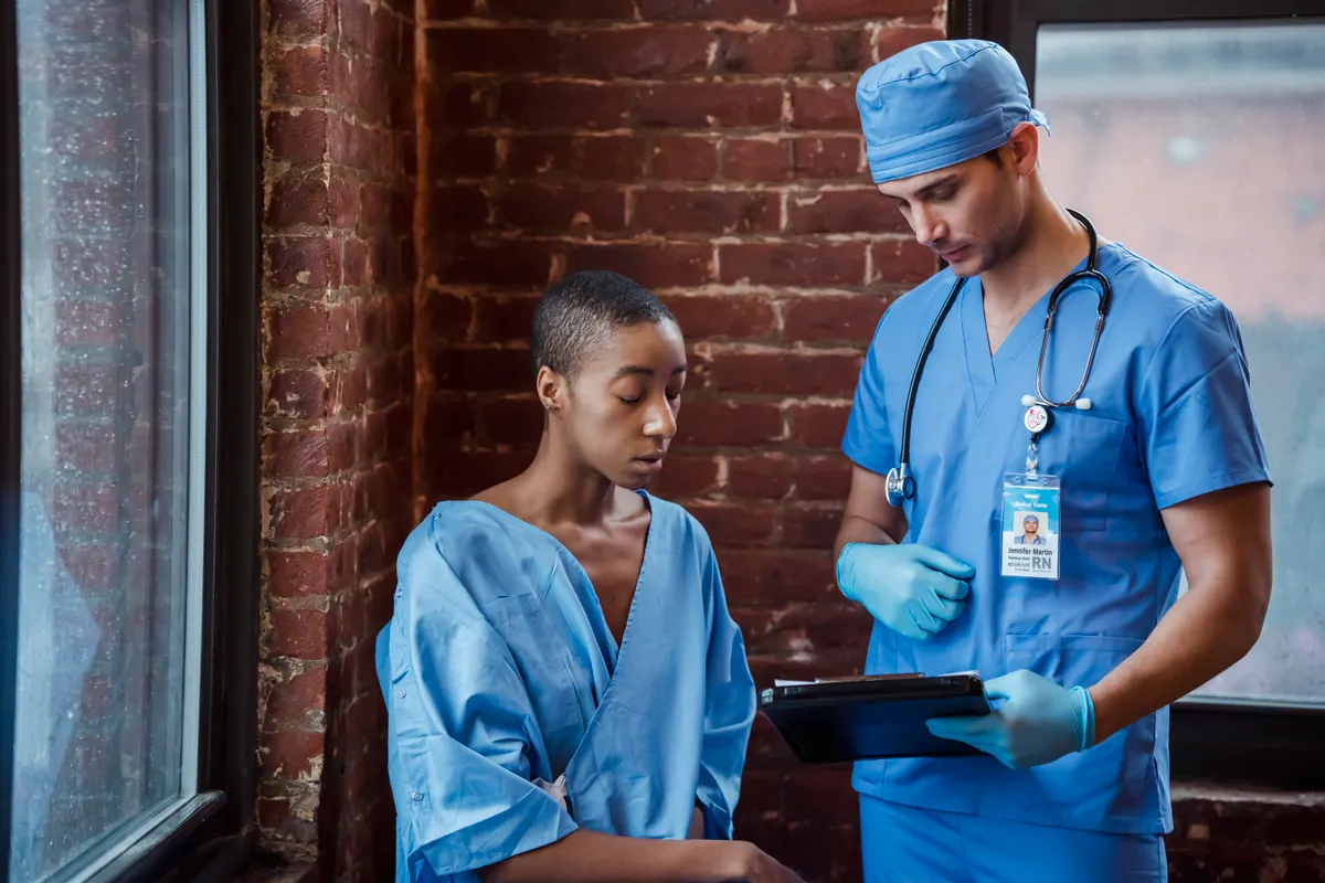 Healthcare professional discussing a chart with a patient