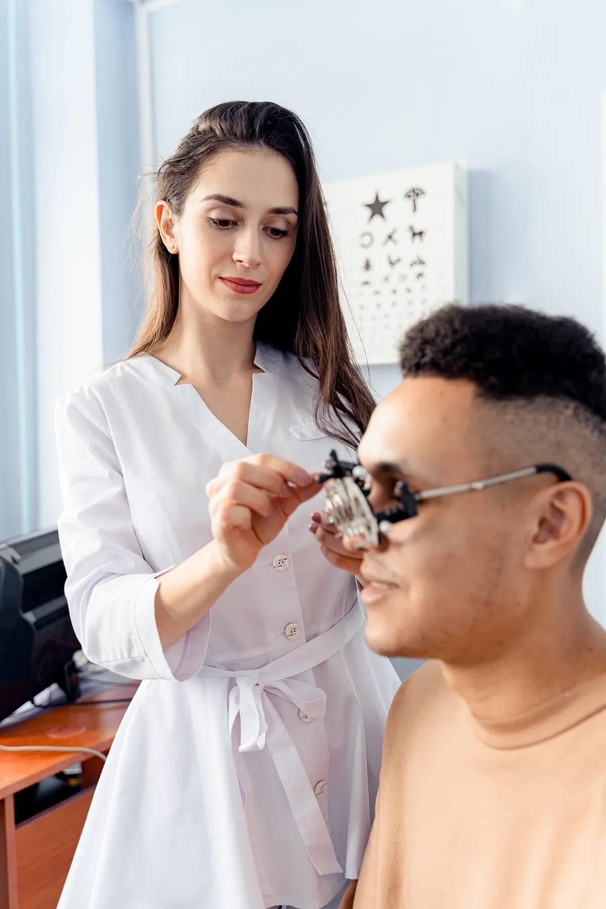 Patient trying examination lenses with an optometrist
