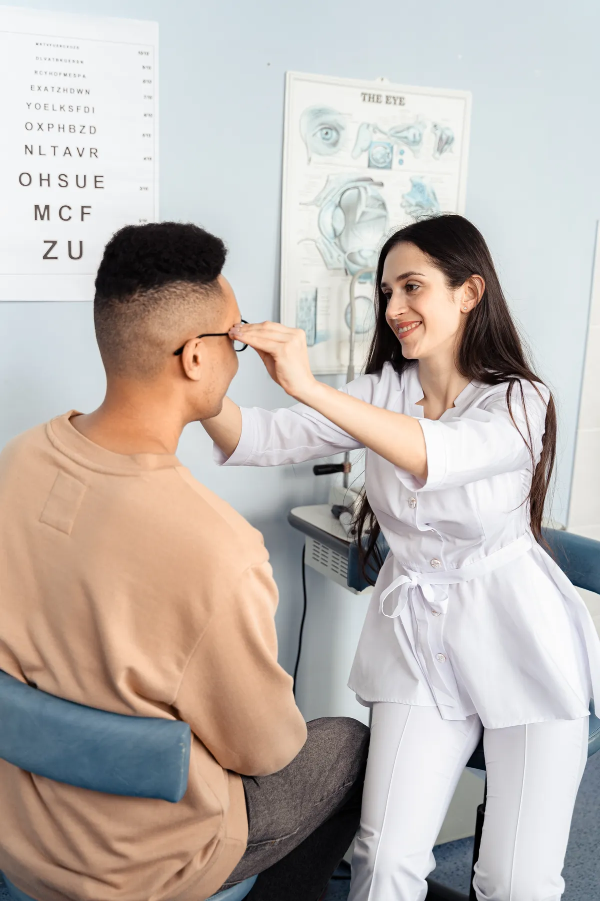 Optometrist fitting examination lenses on a patient