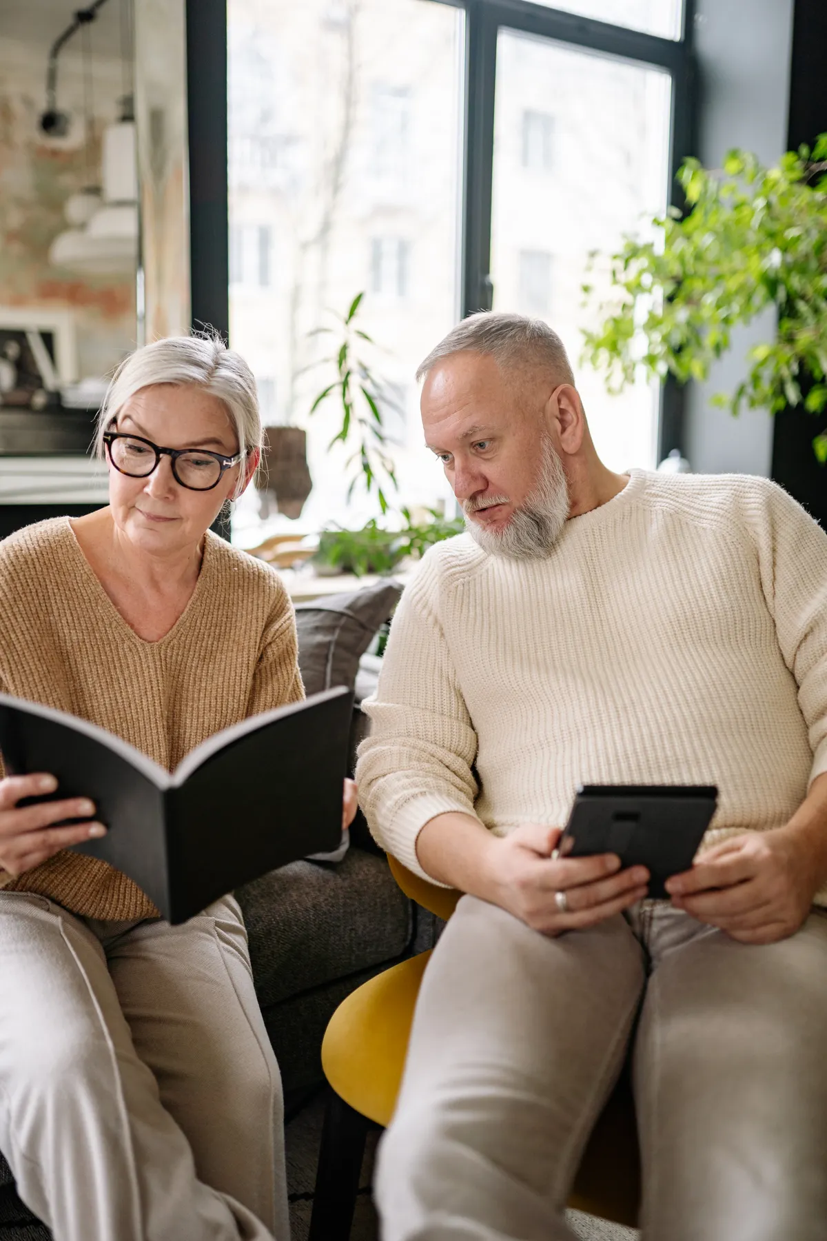 Older couple reading together at home