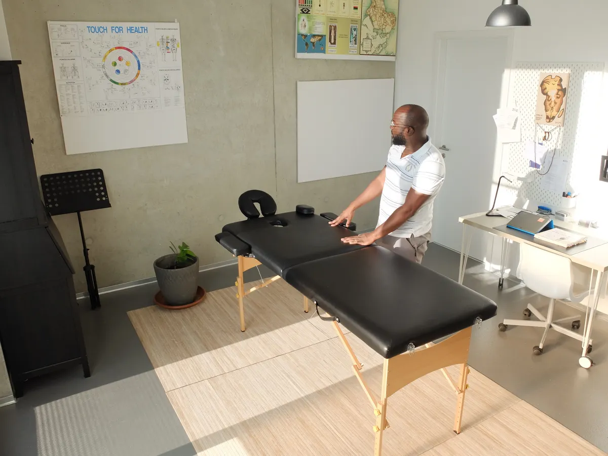 Physical therapist beside an examination table