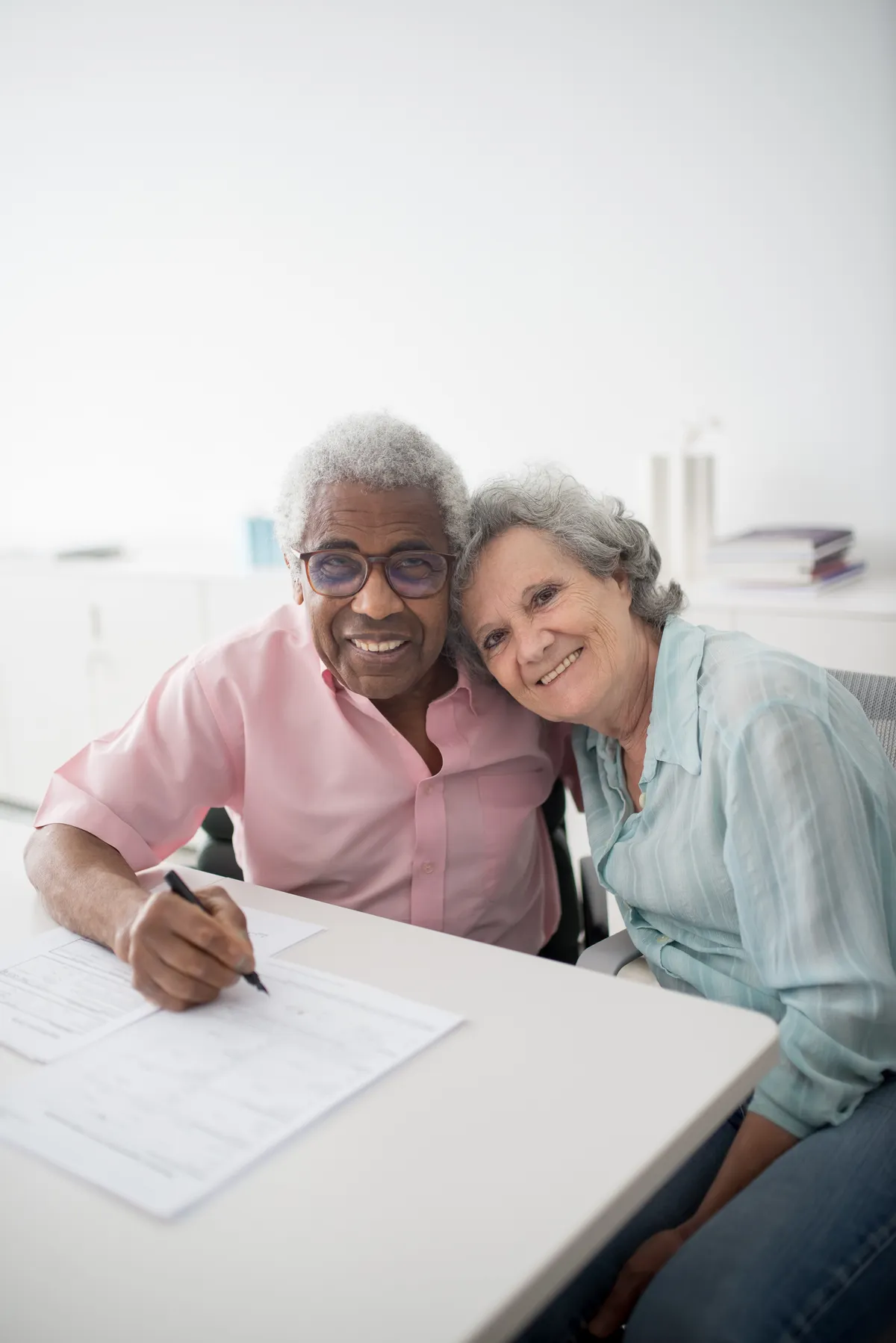Older couple completing a document together