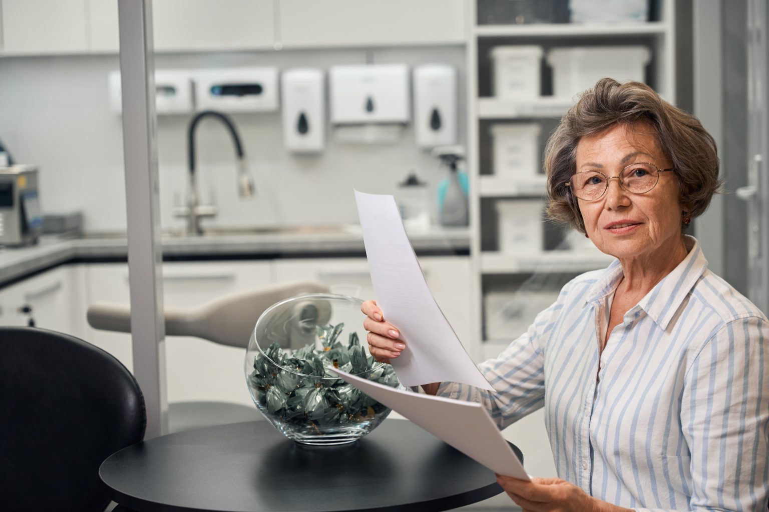An older patient reviewing paperwork with a healthcare professional