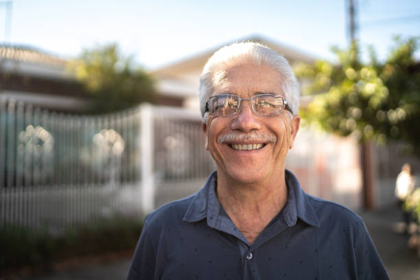 "Smiling elderly man with glasses standing outdoors, symbolizing individuals who may benefit from Medicare Part B coverage for Simponi Aria infusions."

