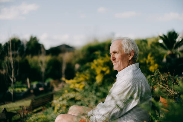 An elderly man sitting outdoors in a garden, gazing into the distance. The image accompanies an article on sleep apnea and treatment options.

