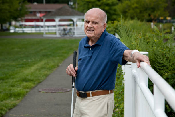 An elderly man walking outdoors with the support of a walking cane, representing Medicare coverage for mobility aids prescribed for seniors.

