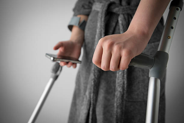 A person gripping a standard walking cane, illustrating one of the various types of canes covered by Medicaid for medical necessity.

